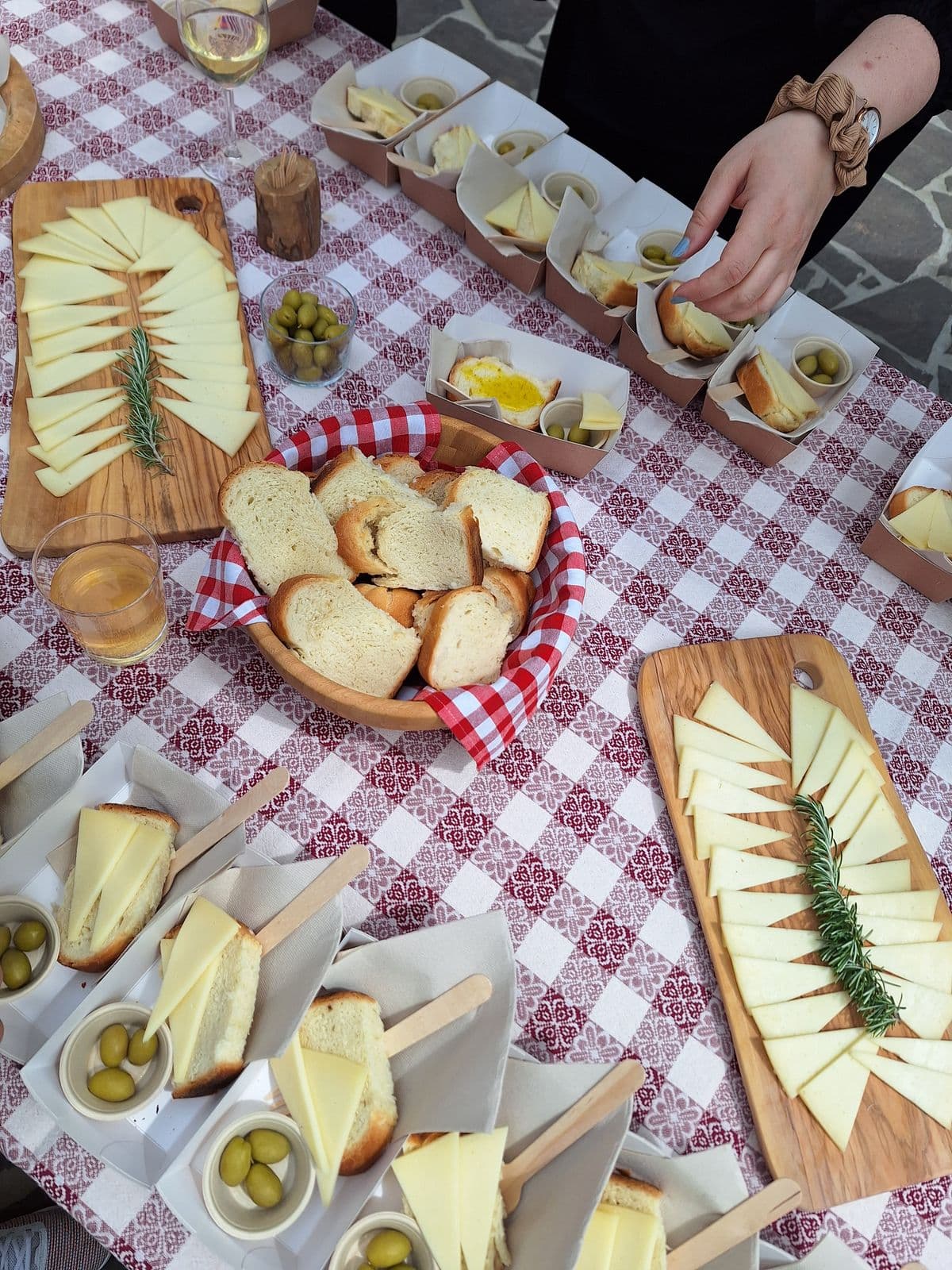Table set with cheese, bread, and olives for tasting